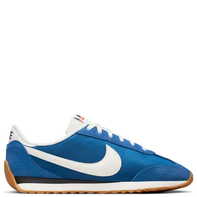 Lateral side view of Nike Pacific Court Blue sneaker featuring puffy white Swoosh and low-profile midsole.