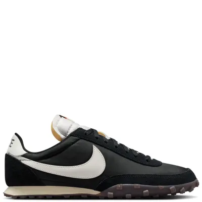 Lateral side view of Nike Waffle Racer featuring Sail leather Swoosh, black suede overlays, and low-profile foam midsole.