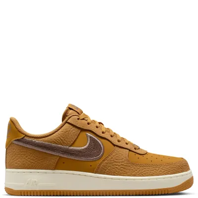 Lateral side view of Nike Air Force 1 ’07 LV8 Wheat sneaker with chain-stitched brown Swoosh and Air midsole.