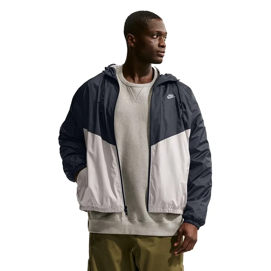 Front view of Nike Windrunner Lined Jacket in black and cream showing chevron design and zip closure