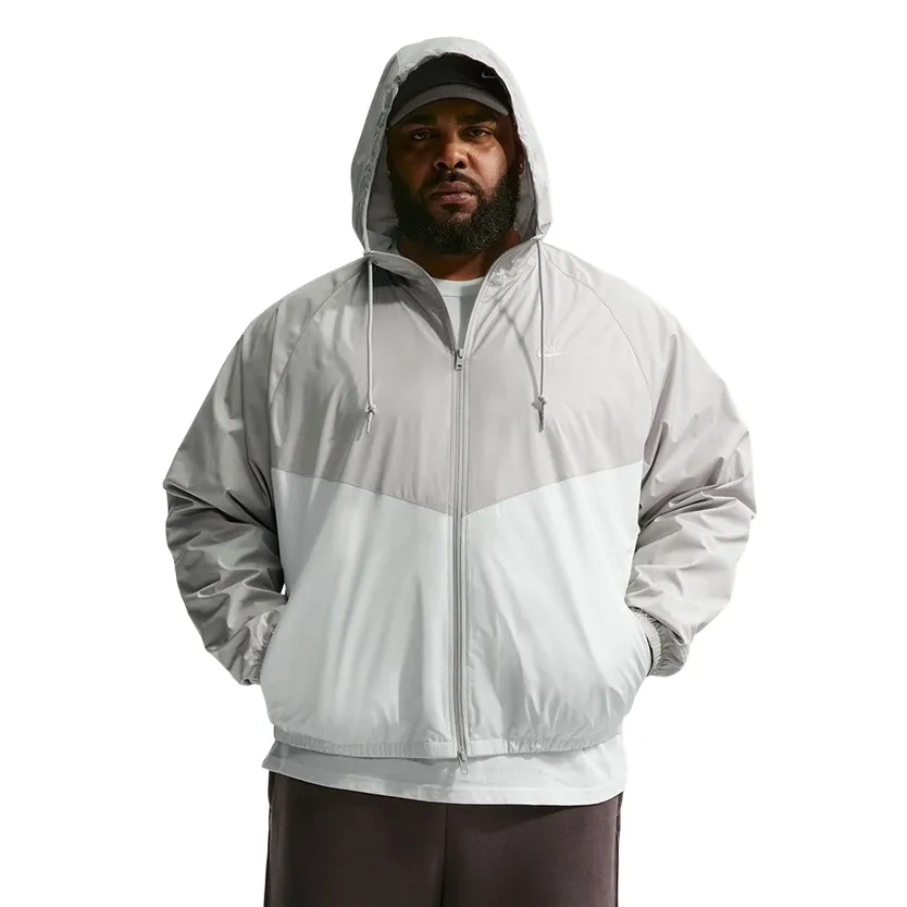 Front view of Nike Windrunner Lined Jacket in light iron ore and sail with chevron panel design