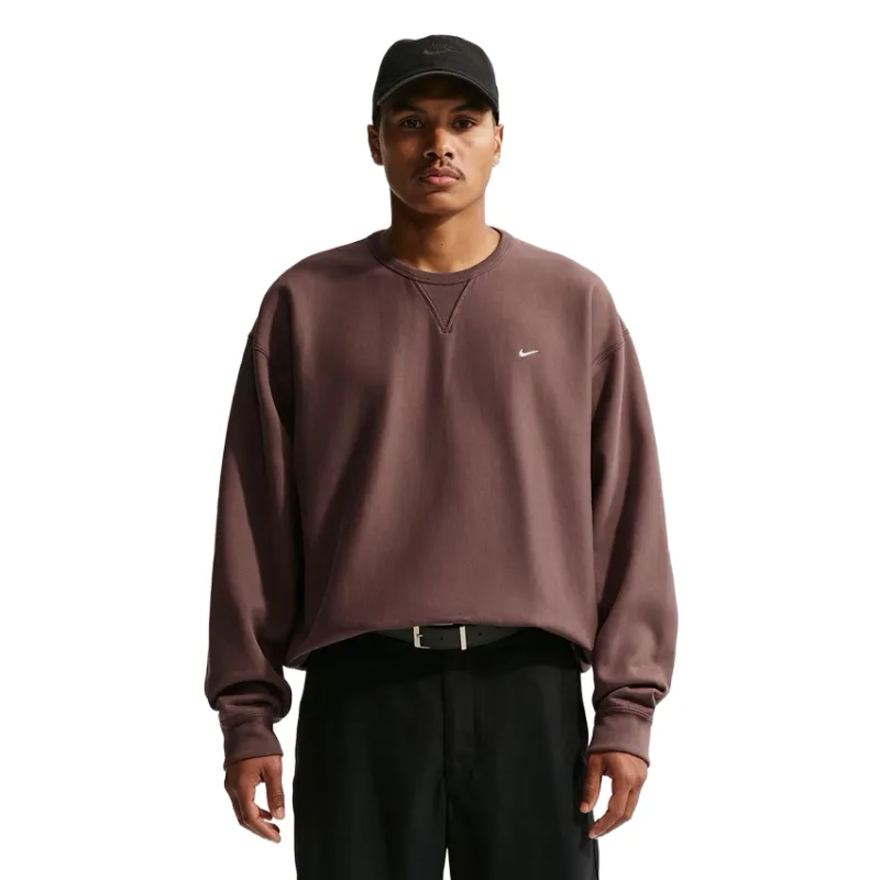 Front view highlighting embroidered Nike Swoosh and crew neckline