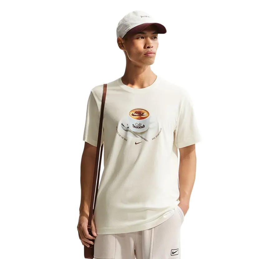 Front view of model wearing Sail tee with Café Swoosh mug graphic on chest