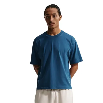Close-up of model wearing court blue Nike tee showing fabric texture and collar