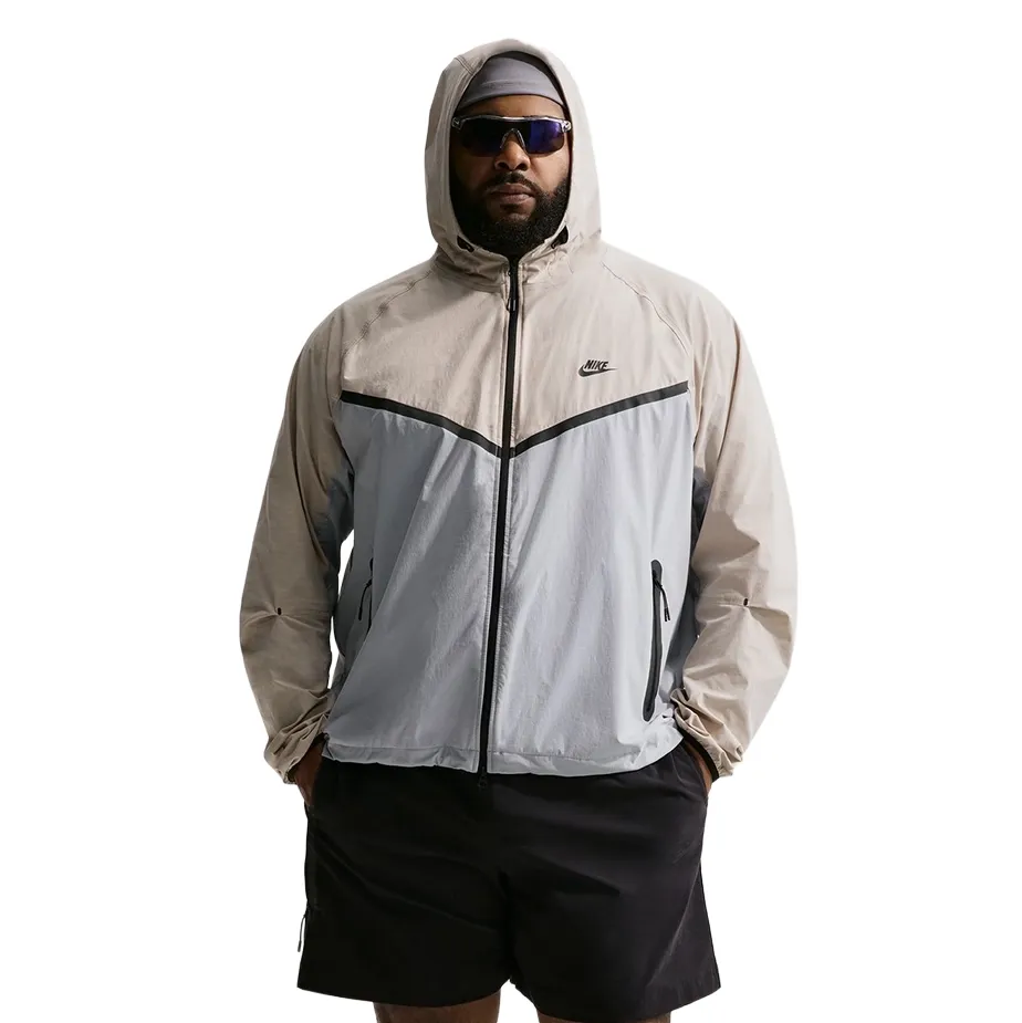 Full front studio view of jacket worn zipped with hands in pockets and black shorts