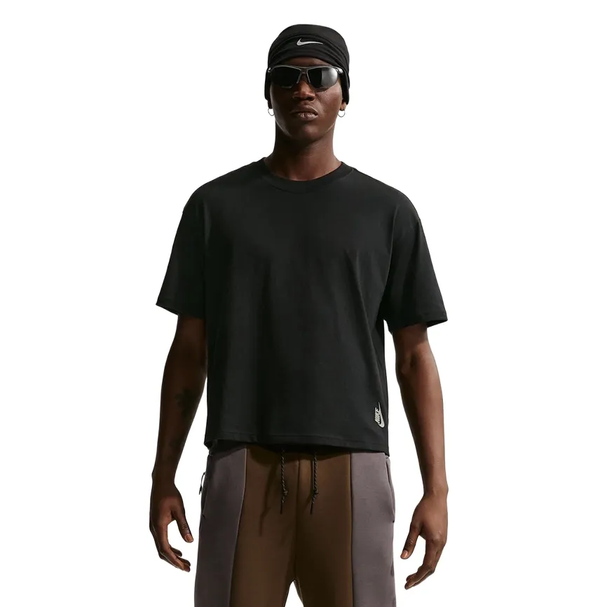 Front view of black Nike boxy tee on model with sunglasses and head covering