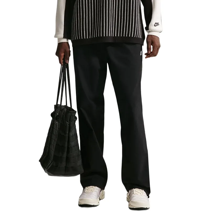 Front view of black Nike Club Barcelona pants with elastic waistband and straight-leg cut