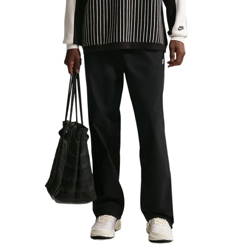 Front view of black Nike Club Barcelona pants with elastic waistband and straight-leg cut