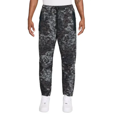 Front view of Nike Tech black print pants showing relaxed fit and elastic waistband