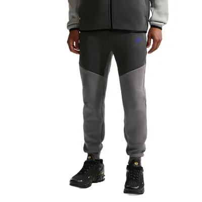 Front view of grey Nike Tech Fleece joggers showing articulated knee panels and tapered fit