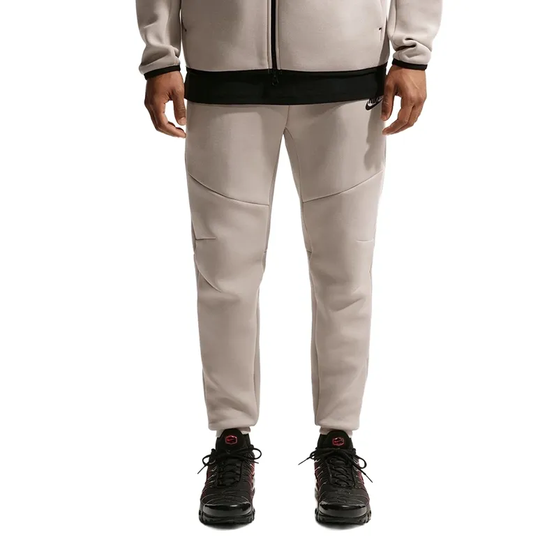 Front view of Cream II Tech Fleece joggers showing elastic waistband and tapered fit