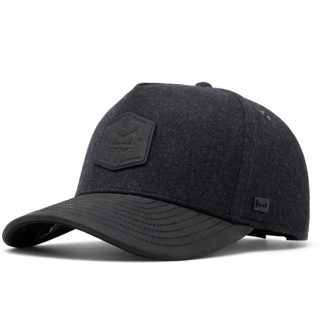 Angled front view of Melin Odysea Scout Thermal black cap with leather visor