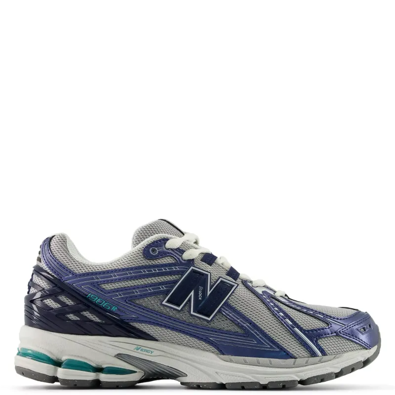 Side view of New Balance 1906R sneaker in navy, raincloud grey, and faded teal
