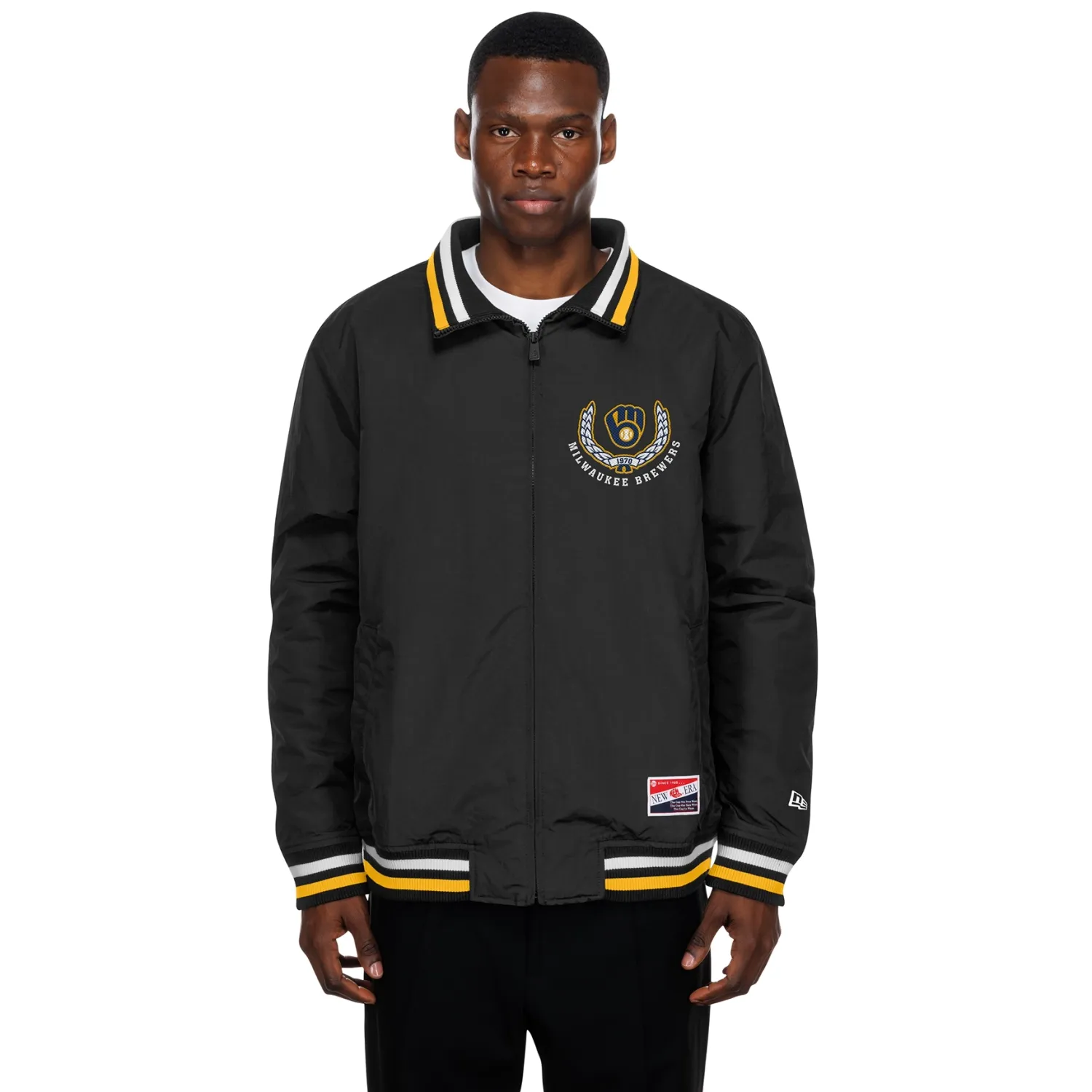 Model wearing black Brewers zip-up jacket featuring embroidered team crest, striped trim, and lightweight shell.