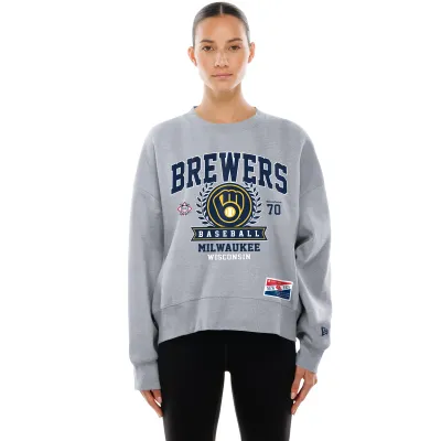 Model wearing grey Brewers women's crewneck featuring large team crest, laurel design, and Brewers lettering.