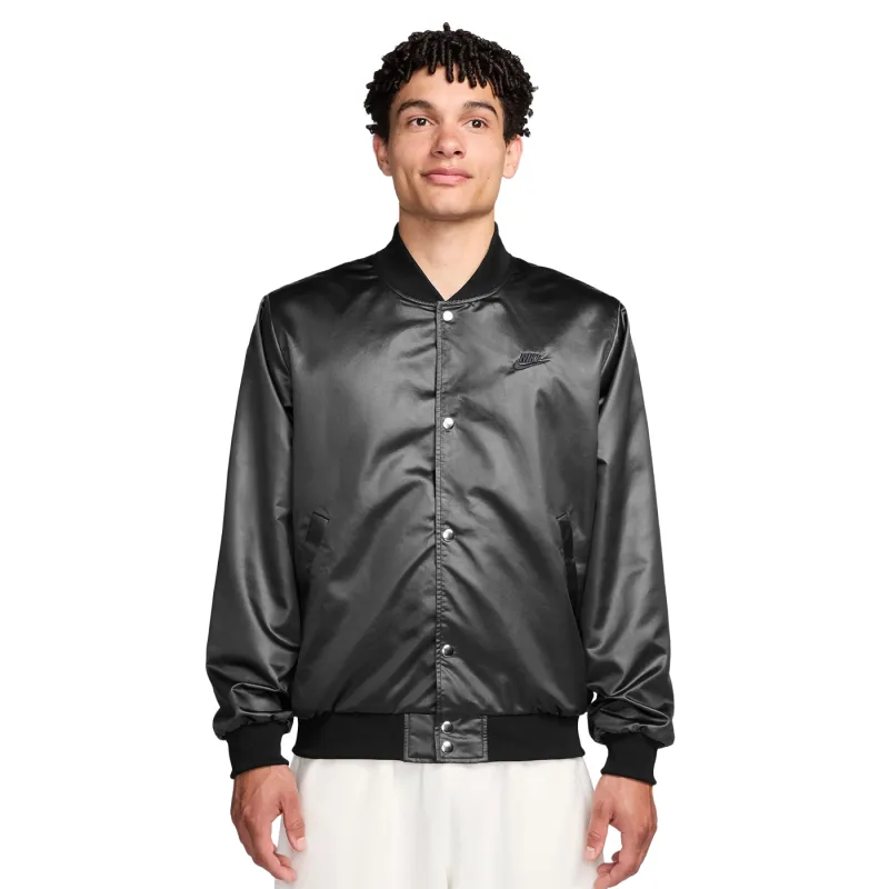 Front view of black satin Nike varsity jacket with snap closure and embroidered logo