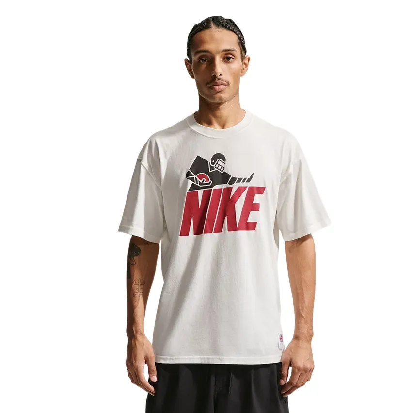 Front view of Nike Football tee featuring large red Nike logo and football player graphic.