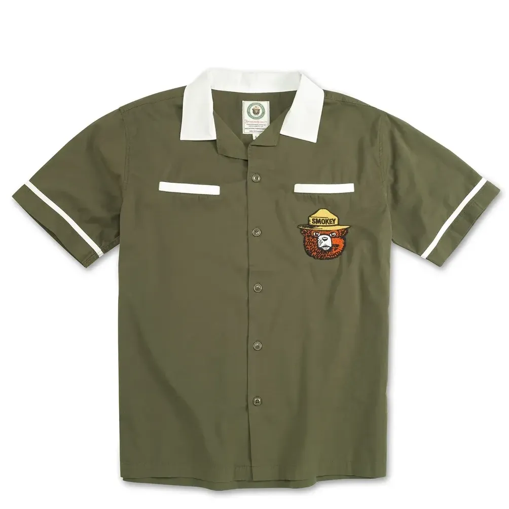 Front view of olive green Smokey Bear bowling shirt with white collar and chest patch