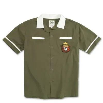 Front view of olive green Smokey Bear bowling shirt with white collar and chest patch