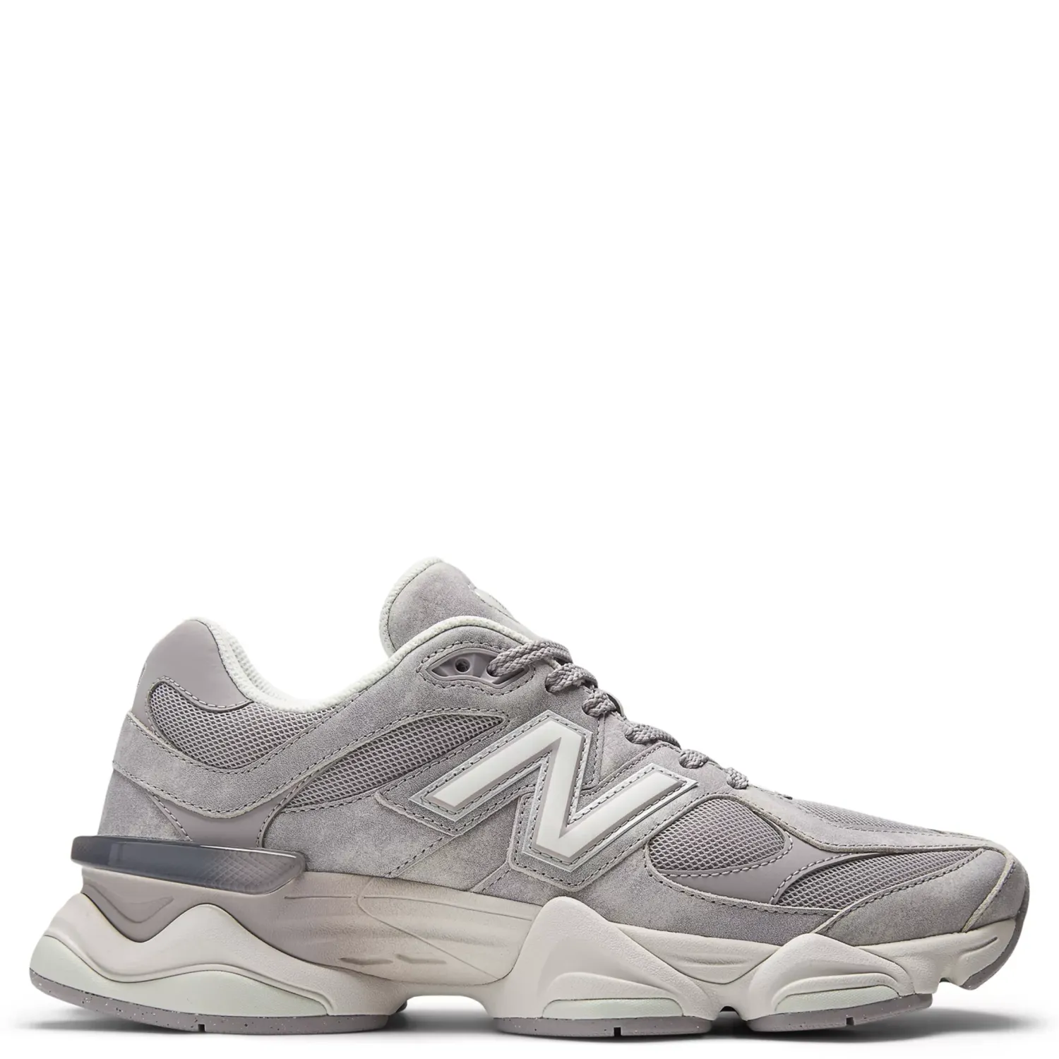 Lateral side view of New Balance 9060 sneaker in soft grey suede and mesh with oversized midsole and sculpted cushioning 