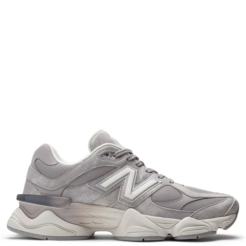 Lateral side view of New Balance 9060 sneaker in soft grey suede and mesh with oversized midsole and sculpted cushioning 