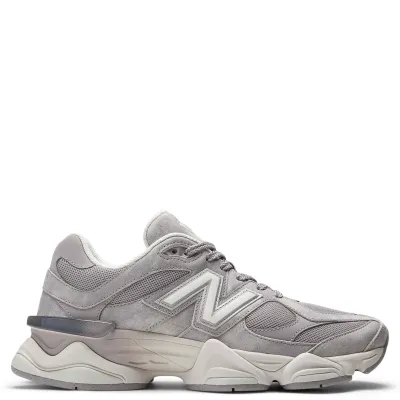Lateral side view of New Balance 9060 sneaker in soft grey suede and mesh with oversized midsole and sculpted cushioning 