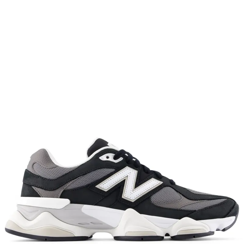 Lateral side view of New Balance 9060 sneaker in black and grey mesh with white “N” logo and chunky sculpted midsole.