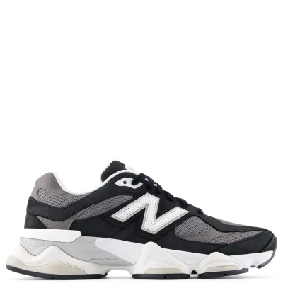 Lateral side view of New Balance 9060 sneaker in black and grey mesh with white “N” logo and chunky sculpted midsole.