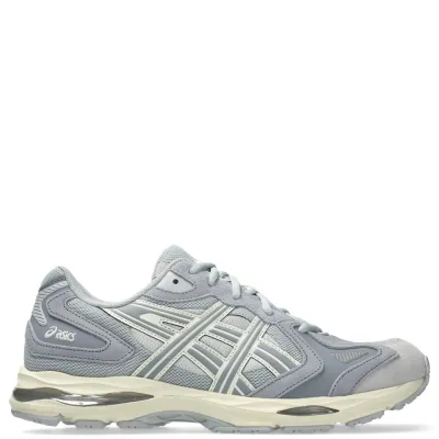 Side profile of ASICS GEL-K1011 emphasizing GEL cushioning, sculpted midsole, and durable outsole.