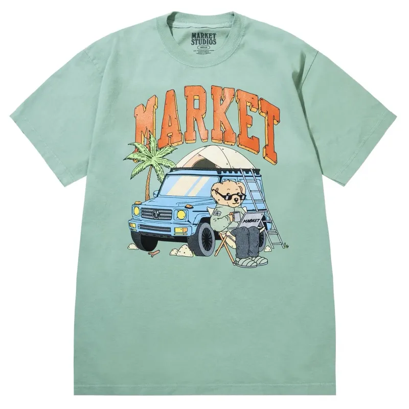 Front view of Market Studios green t-shirt with “MARKET” text and bear camping by SUV graphic
