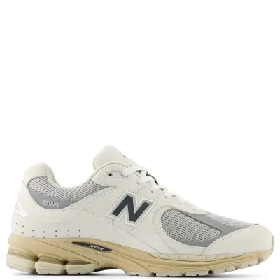 Side profile of the New Balance 2002R in Linen and Raincloud with suede overlays, mesh underlays, and cushioned sole