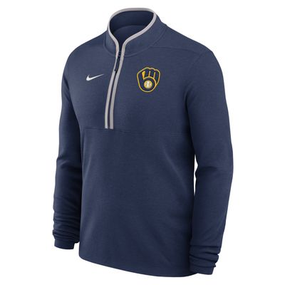 Front angled view of navy Milwaukee Brewers Nike half zip pullover with team glove logo and white Swoosh