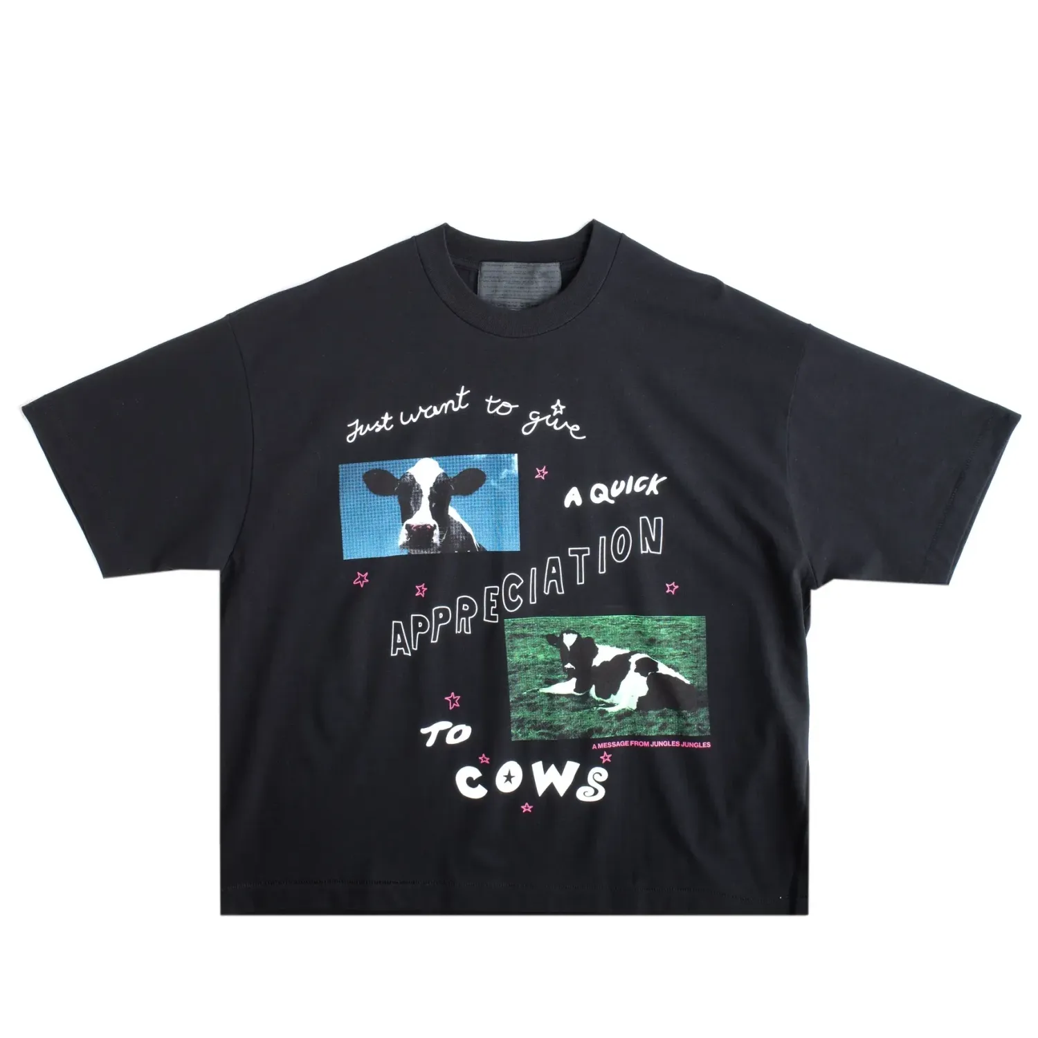 Front view of black Jungles tee with cow graphic and playful text design.
