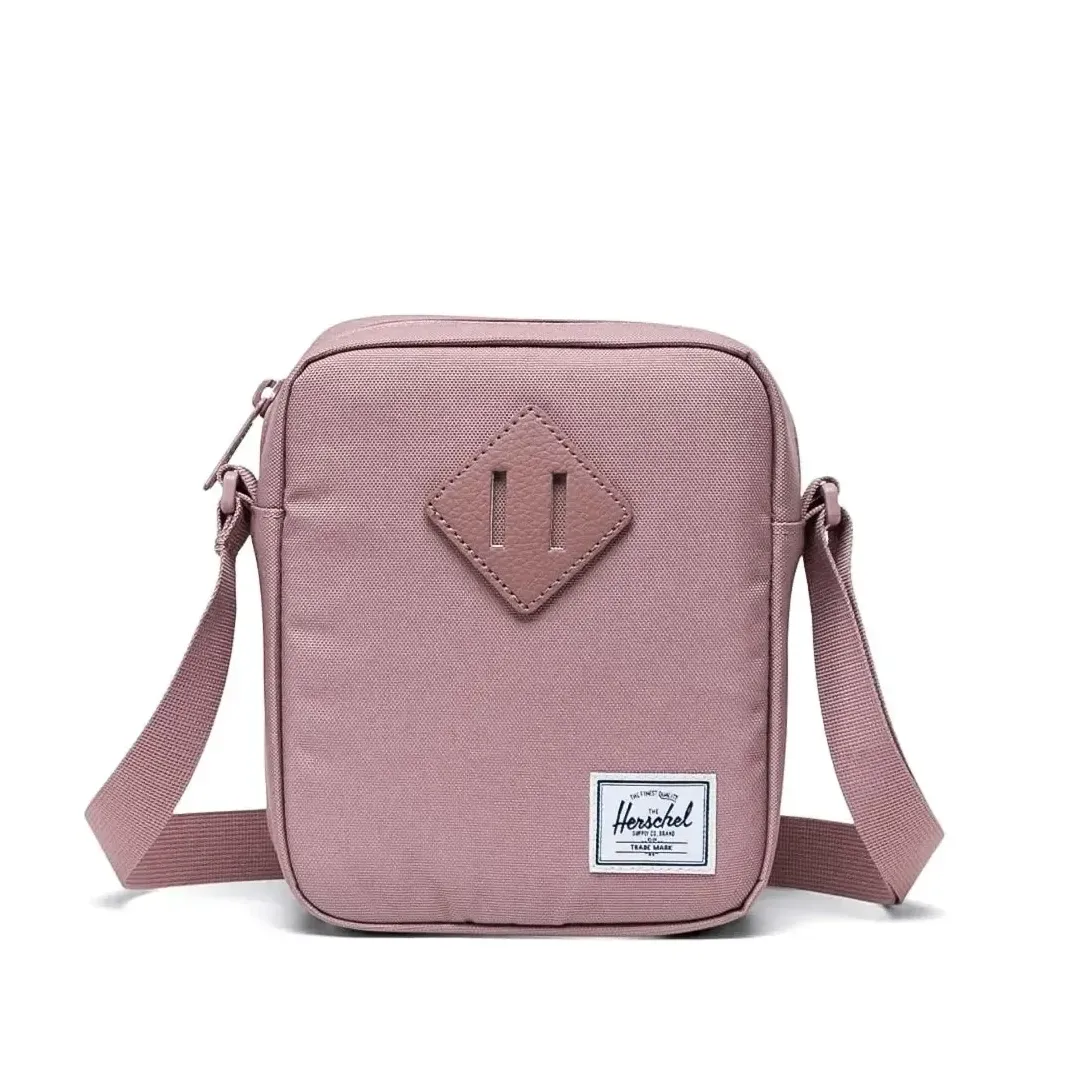 Front view of Herschel Heritage crossbody bag in ash rose with signature diamond detail
