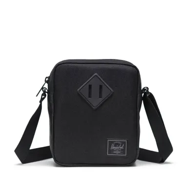 Front view of Herschel Heritage crossbody bag in black tonal with signature diamond detail