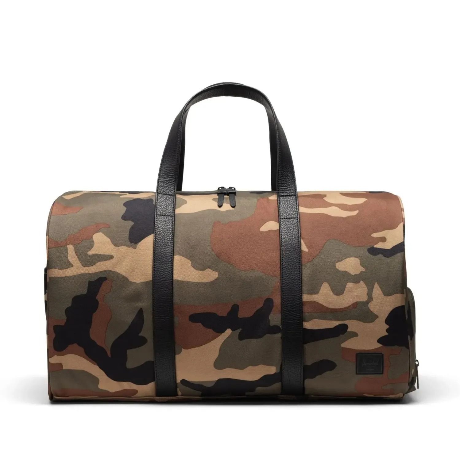 Front view of Herschel Novel duffle bag in woodland camo with black handles