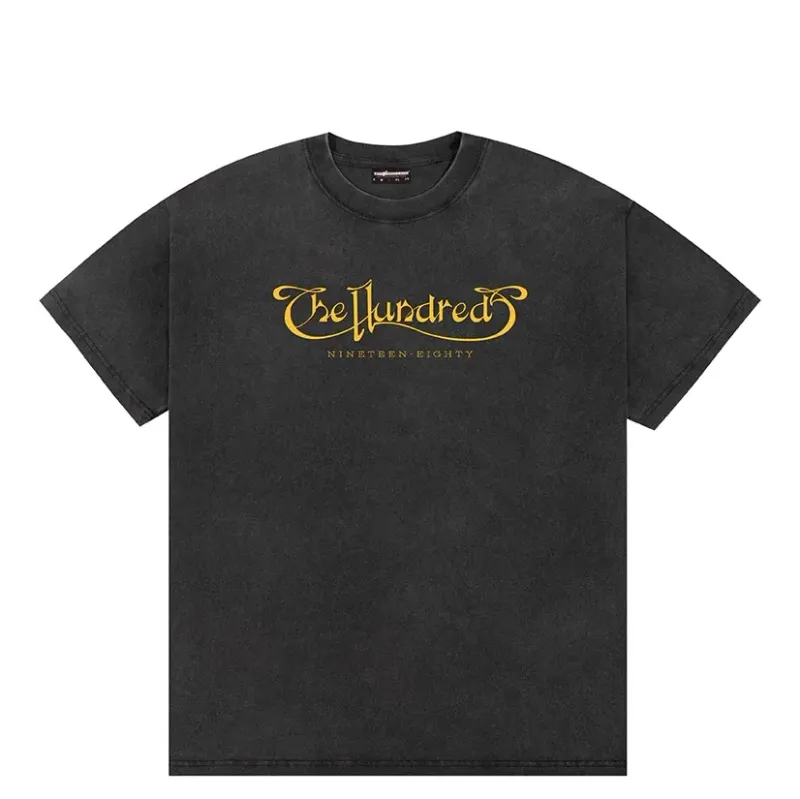 Front view of washed black t-shirt with gold The Hundreds script logo graphic