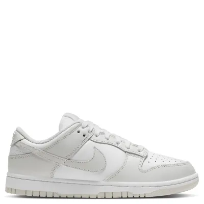 Medial side view of Nike Dunk Low in white and light grey with clean stitched overlays