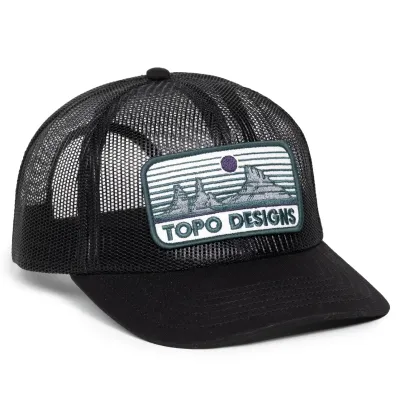 Angled front view of TOPO DESIGNS Desert Dusk trucker hat with flat brim and mesh crown