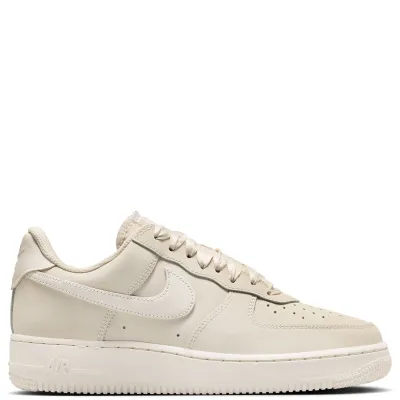 Full lateral side view of Nike Air Force 1 Retro Premium sneakers in soft neutral tones