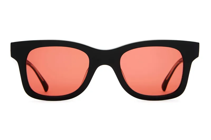 Front view of The Suntan Underground sunglasses featuring a classic square black frame and deep rose lenses.