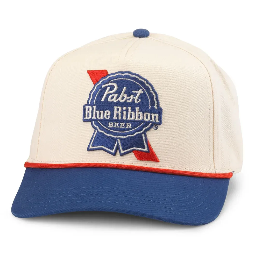 Front view of American Needle Pabst Blue Ribbon Scottie hat in ivory and royal with embroidered beer logo