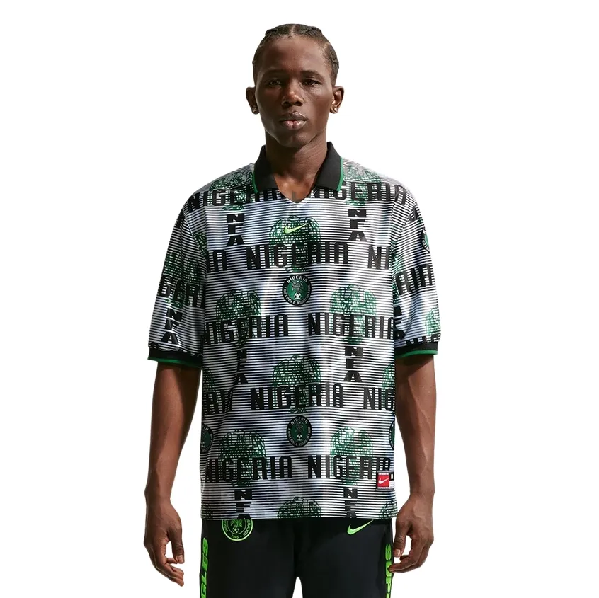 Front view of model wearing Nike Nigeria Energy Soccer Jersey in White and Black with bold Nigeria-themed graphics.
