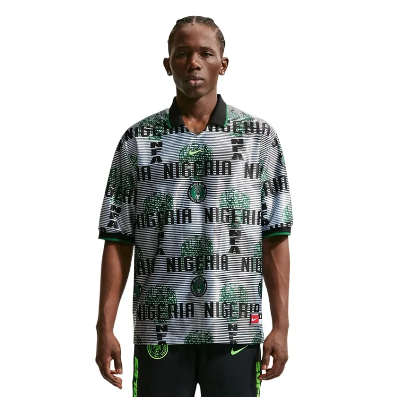 Front view of model wearing Nike Nigeria Energy Soccer Jersey in White and Black with bold Nigeria-themed graphics.