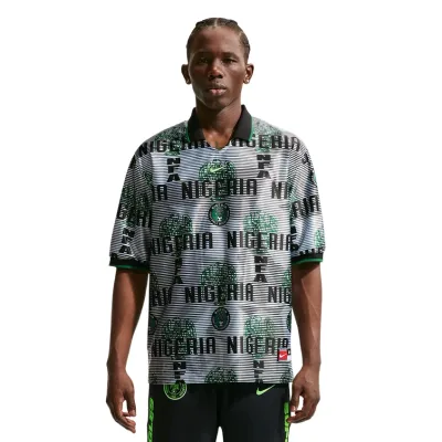 Front view of model wearing Nike Nigeria Energy Soccer Jersey in White and Black with bold Nigeria-themed graphics.