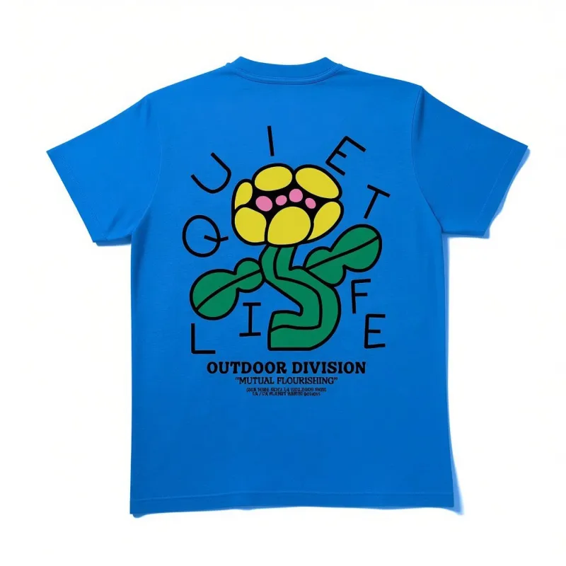 Back view of The Quiet Life Mutual Flourishing T-shirt in royal blue featuring oversized flower artwork and Outdoor Division 
