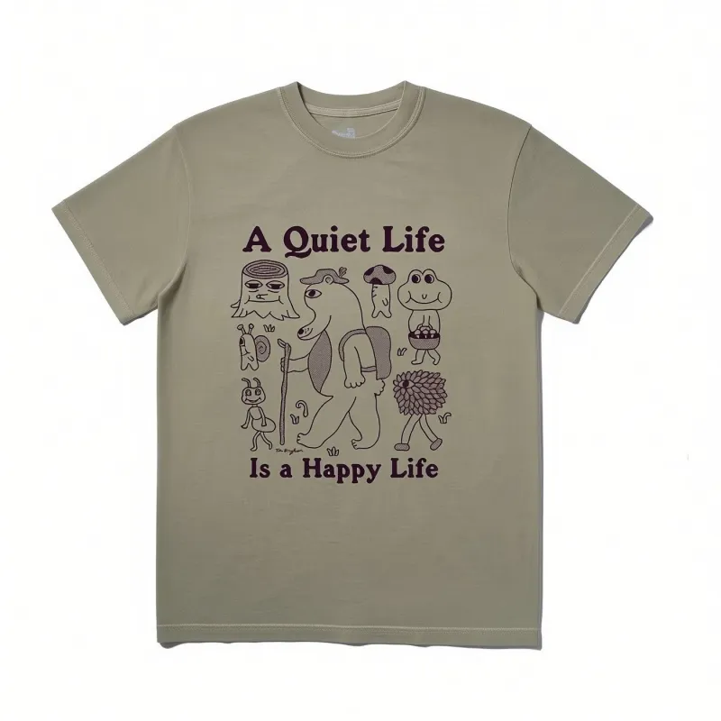 The Quiet Life Happy Life T-shirt in khaki featuring illustrated character artwork and slogan graphic printed on the front.