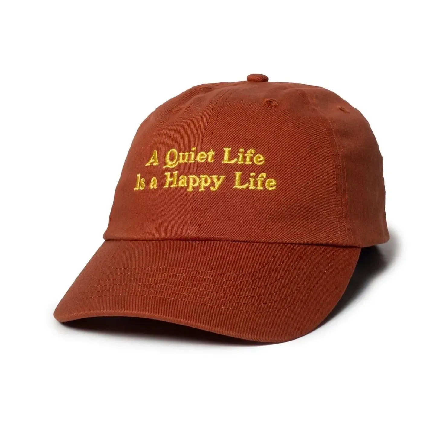 The Quiet Life Happy Life Dad Hat in rust with yellow embroidered front artwork.