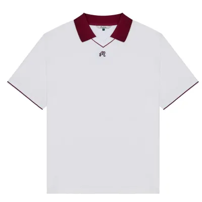 Malbon Golf Barrio Polo in Bright White shown from the front with burgundy collar and chest logo.