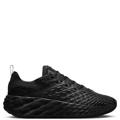 Medial side profile of Nike Ava Edge featuring woven grid upper, black Swoosh, and oversized textured midsole.